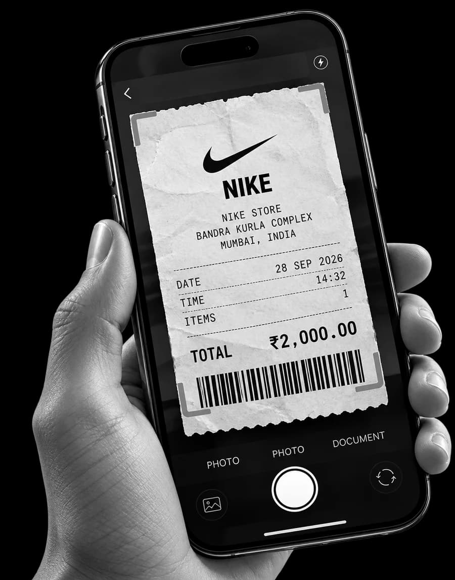 A hand holding a phone that is scanning a Nike receipt for ₹2,000 dated 28 Sep 2026